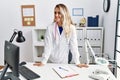Young woman wearing doctor uniform smiling confident standing at clinic Royalty Free Stock Photo