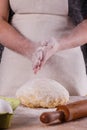 Young woman wearing a duck on a wooden board in an apron