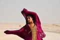 Young woman wearing eastern dress in arabic desert Royalty Free Stock Photo