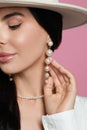 Young woman wearing elegant pearl jewelry on pink background, closeup Royalty Free Stock Photo