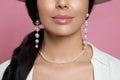 Young woman wearing elegant pearl jewelry on pink background, closeup Royalty Free Stock Photo