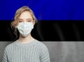 Young woman wearing a face mask with estonian national flag. Flu epidemic and virus protection concept