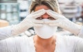 Young woman wearing face mask and gloves for coronavirus prevention - Stop spreading Covid 19 concept - Focus on hands Royalty Free Stock Photo