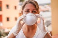 Young woman wearing face mask and latex gloves for coronavirus prevention -  Stop spreading Covid 19 concept - Focus on hands Royalty Free Stock Photo