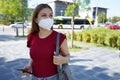 Young woman wearing FFP2 KN95 face mask on city street