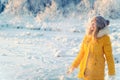 Young Woman wearing gloves playing with snow outdoor Winter vacations