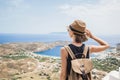 Young woman traveler looking at the sea. Beautiful girl enjoying nature. Summer holidays, vacations, travel, tourism concept