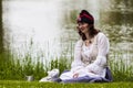 Woman of the napoleonic period sitting on the grass