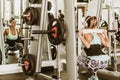 Woman lifting weights behind head