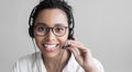 Young woman wearing headset. Closeup portrait of customer service assistant talking on phone.
