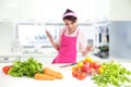 Young woman wearing kitchen apron with tablet