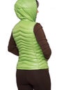 Young woman wearing light green hooded packable down puffer vest