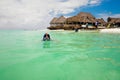 Young woman wearing mask for snorkeling in the turquoise ocean