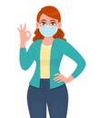 Young woman wearing medical mask and showing okay, OK sign. Trendy girl covering face protection from epidemic and gesturing Royalty Free Stock Photo