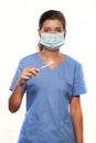 Young Woman Wearing Medical Scrubs and a Surgical Mask and Holding a Toothbrush Royalty Free Stock Photo