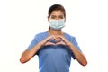 Young Woman Wearing Medical Scrubs and a Surgical Mask Royalty Free Stock Photo