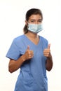 Young Woman Wearing Medical Scrubs and a Surgical Mask Royalty Free Stock Photo