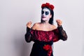 Young woman wearing mexican day of the dead makeup doing money gesture with hands, asking for salary payment, millionaire business