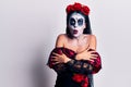 Young woman wearing mexican day of the dead makeup shaking and freezing for winter cold with sad and shock expression on face Royalty Free Stock Photo