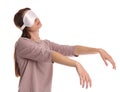 Young woman wearing pajamas and mask in sleepwalking state on white background