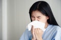 A young woman is ill and snot. flu season. Achoo