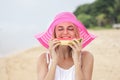 Young woman wearing pink sunhat eating fresh watermelon Royalty Free Stock Photo