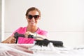 Young woman wearing pink t shirt and sunglasses cleaning her car in self serve carwash, banner with space for text right side Royalty Free Stock Photo