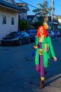 Young Woman Wearing a Poboy Hat Walks down Leonidas Street towards the Poboy Fest