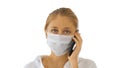 Young woman wearing Protective Face Mask making a call walking on white background. Royalty Free Stock Photo