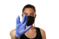 Young woman wearing protective mask on face and medical gloves. Showing vulcanian sign. Confident girl, female doctor in medical Royalty Free Stock Photo