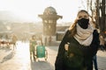 Young woman wearing a protective mask with a valve. Living in the polluted city. Coronavirus COVID-19 pandemic mandatory masks on