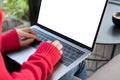 woman wearing red sweater typing on computer at home. female adult sitting on armchair using laptop at cafe. education, working c Royalty Free Stock Photo