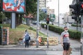 Young woman wearing a respiratory face mask making a phone call on her smartphone apps in the street of Belgrade