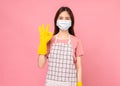 Young woman wearing rubber gloves and shows ok sign on pink background Royalty Free Stock Photo