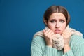 Young woman wearing scarf suffering from fever on background, space for text. Cold symptoms Royalty Free Stock Photo