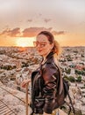Young woman wearing shades watching sunset. Cappadocia.