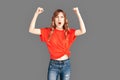 Freestyle. Woman in sports clothes studio standing isolated on grey supporting favorite team shouting motivated Royalty Free Stock Photo