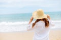 Young woman wearing straw hat on the beach. Royalty Free Stock Photo