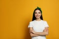 Young woman wearing stylish bandana on orange background, space for text Royalty Free Stock Photo