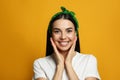 Young woman wearing stylish bandana on orange background Royalty Free Stock Photo