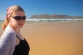 Young woman wearing sunglasses on the beach at Muizenberg Royalty Free Stock Photo