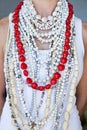 Young woman wearing white beads and one string of hearts