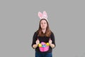Young women wearing bunny rabbit ears holding Easter egg basket sulking expression Royalty Free Stock Photo