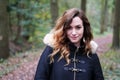 Young woman wearing winter coat in forest Royalty Free Stock Photo