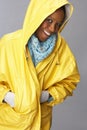 Young Woman Wearing Yellow Raincoat In Studio