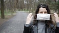 Young woman wears protective medical mask on face in midst of pandemic. copy space Royalty Free Stock Photo