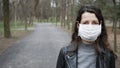 Young woman wears protective medical mask on face in midst of pandemic. copy space Royalty Free Stock Photo