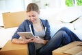 Young woman websurfing on tablet in new flat