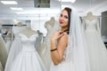 Young woman in wedding dress and veil in bridal shop Royalty Free Stock Photo