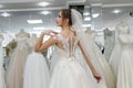 Young woman in wedding dress and veil in bridal shop Royalty Free Stock Photo